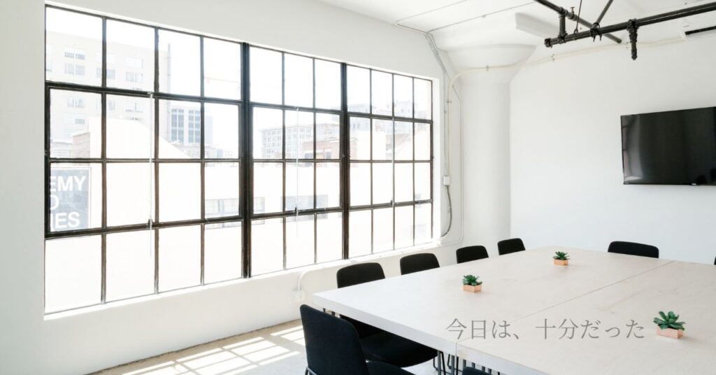 静かな会議室に差し込む朝の光とテーブル